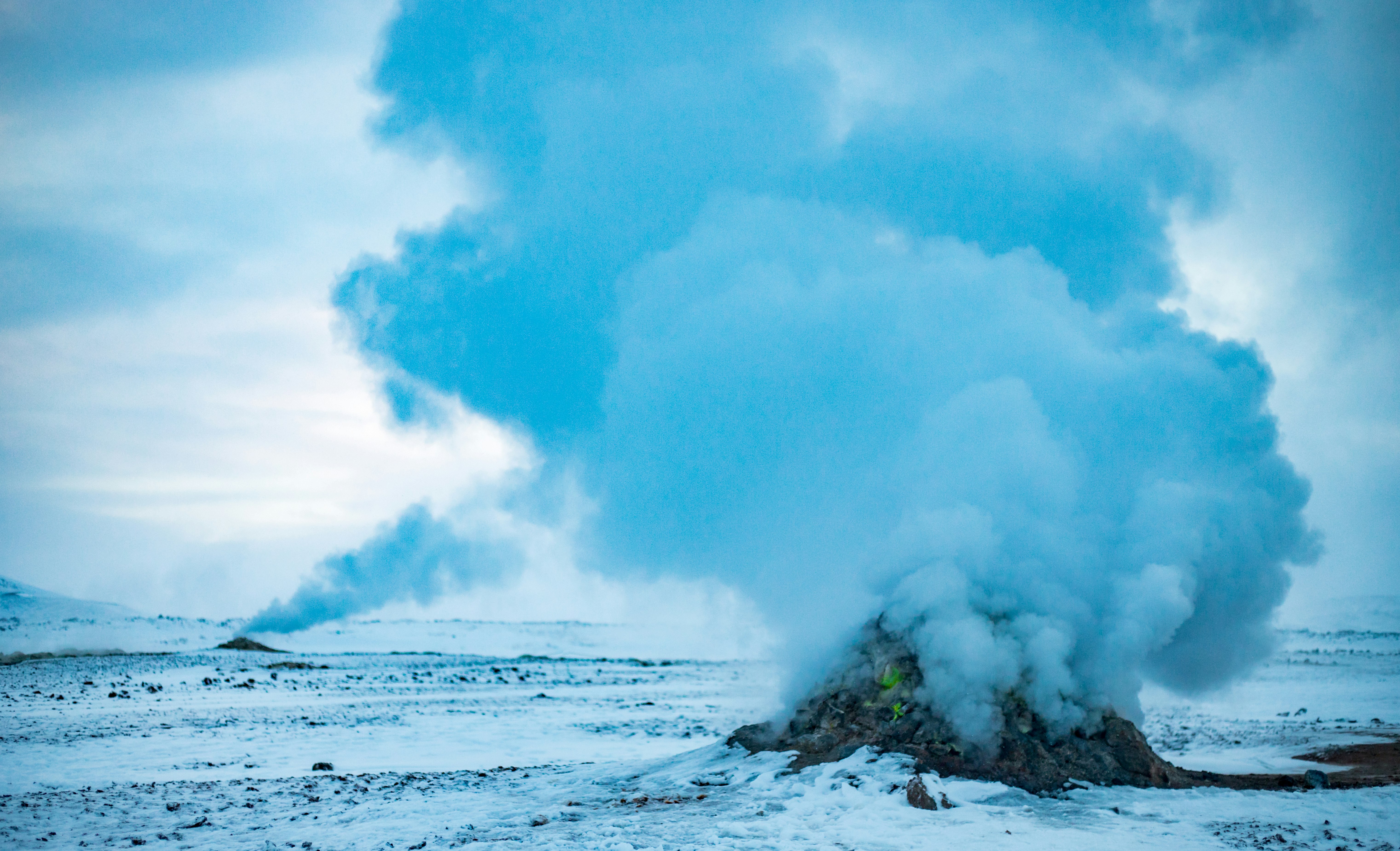 landscape photography of rock bursting smoke